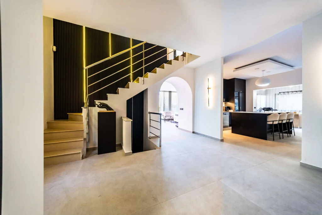 HDR photo of a villa hallway with a staircase and open-plan kitchen
