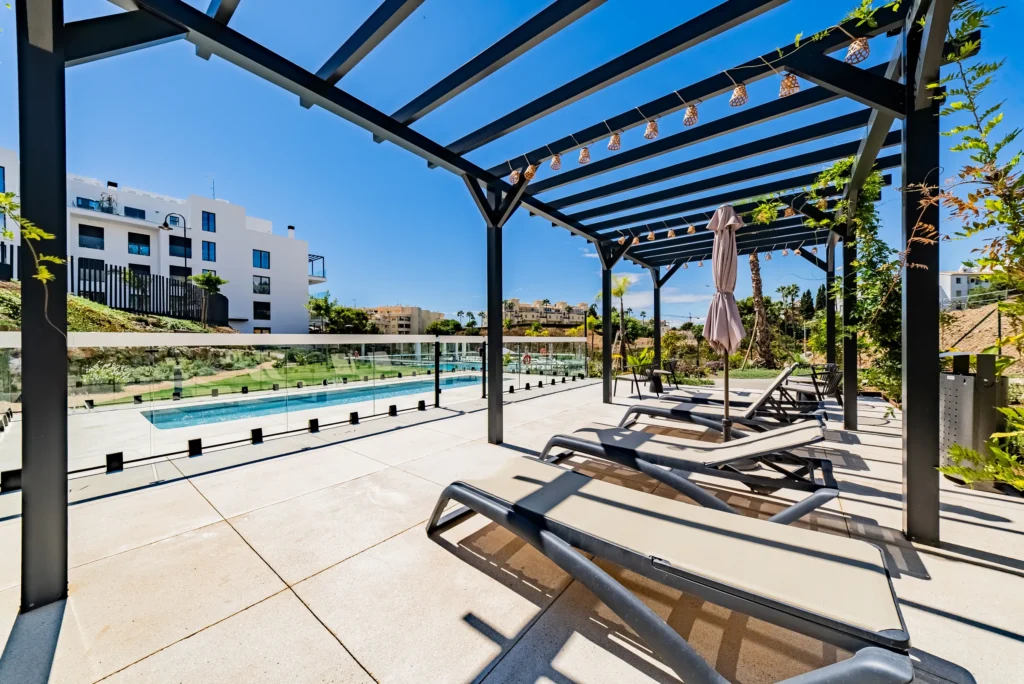 Sun loungers beside a long communal pool