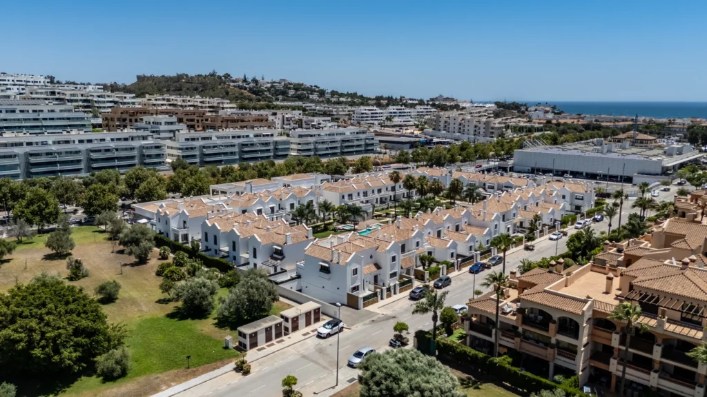 Drone photo of townhouses and apartments with the sea on the horizon, Costa del Sol