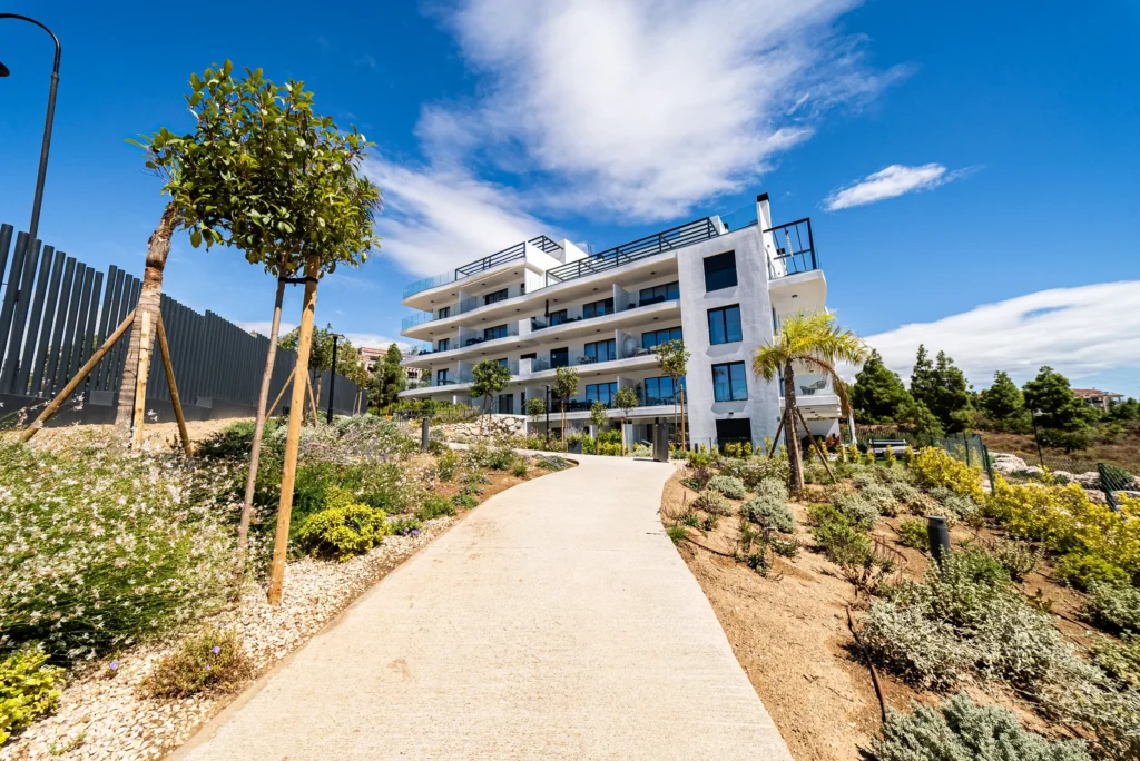 New-build apartment block with a landscaped garden path